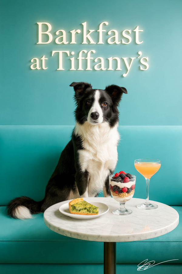 Border Collie seated on a turquoise tufted banquette behind a marble table with a slice of spinach quiche, a layered berry parfait glass, and a peach cocktail