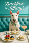 Bull Terrier in a floral scarf lounges on a turquoise tufted banquette beside a white-draped table with three fruit tarts, two plates of cucumber tea sandwiches, a porcelain coffee cup and a peach-cocktail under “Barkfast at Tiffany’s” script