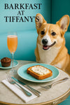 Smiling corgi seated at turquoise café booth beside marble table with whipped-topped toast chocolate muffin coupe cocktail and neon Barkfast at Tiffany’s sign