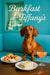 Dachshund on turquoise booth beside wooden table with raspberry scones cream bowl cucumber tea sandwiches and peach cocktail before gift-box display