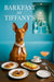 Pharaoh Hound seated on a teal banquette beside a dark wood café table with two fig tartlets scrambled eggs toast a coffee cup and a pink spritz