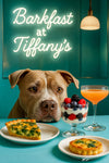 Pit Bull peering over a teal banquette café table with a slice of spinach quiche, two mini spinach tarts, a berry parfait in a jar, and a pink spritz