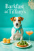 Jack Russell Terrier wearing a turquoise scarf seated on a tufted teal banquette under a crystal chandelier in an elegant café interior