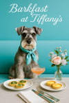 Whiskered Schnauzer wearing a turquoise scarf seated on a teal café banquette beside a vase of pastel flowers