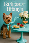 Yorkshire terrier wearing a turquoise scarf standing next to a teal pedestal table with ricotta crostini berry tarts a peach cocktail and white peonies in a vase
