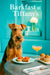 Airedale Terrier enjoying brunch at a turquoise Tiffany’s café table with a cocktail and muffins