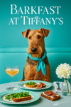 Airedale Terrier wearing a Tiffany blue scarf seated at a brunch table with fig toast, arugula tartlets, mimosa, and a white bloom