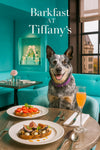 Australian Cattle Dog wearing a purple collar seated at a Tiffany-blue café table with fig-topped toast, tomato-basil toast, and a peach cocktail by a city-view window