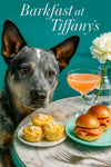 Australian Cattle Dog seated at a Tiffany-blue café table with savory corn-and-cheese muffins, smoked-salmon brioche sliders, a peach cocktail, and a white dahlia