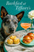 Australian Cattle Dog seated at a Tiffany-blue café table with savory corn-and-cheese muffins, smoked-salmon brioche sliders, a peach cocktail, and a white dahlia