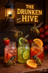 Wasps drinking colorful mason-jar cocktails under a “The Drunken Hive” sign on a Metal Print