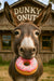 Playful donkey holding a sprinkled donut outside rustic donut shop metal print wall art