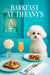 Fluffy Bichon Frise seated at a Tiffany-blue banquette with fig-and-nut topped toast, blueberry muffins, a peach cocktail flute, a white flower in a vase, and a jewelry gift-box display