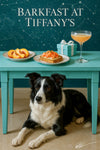 Border Collie peeking from under a turquoise table with plates of sliced peaches, smoked-salmon toast, a frothy cocktail, a Tiffany-blue gift box, and a chalk constellation backdrop