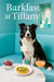 Border Collie seated on a turquoise tufted banquette behind a marble table with a spinach quiche tart, a layered berry parfait glass, and a peach cocktail