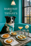Border Collie wearing a teal scarf seated in a turquoise booth next to a table with a peach Danish, ricotta-topped toasts, water glasses, a peach cocktail, and a white dahlia bloom