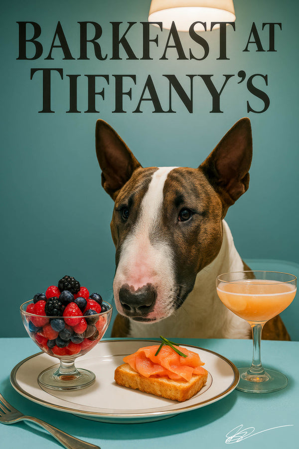 Sleek Bull Terrier seated behind a Tiffany-blue banquette with smoked-salmon toast, a glass bowl of mixed berries and a peach-hued cocktail under “Barkfast at Tiffany’s” lettering