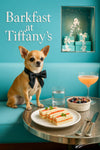 Chihuahua in black bowtie seated on turquoise banquette next to metal table with finger sandwiches, berries, water, cocktail and gift boxes