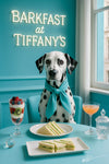 Dalmatian wearing turquoise scarf seated at matching table with layered fruit parfait cucumber tea sandwiches frothy cocktail and cut glass jar beneath neon Barkfast at Tiffany’s sign