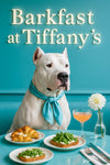 Dogo Argentino wearing turquoise scarf seated on a tufted blue banquette beside table with cheese-topped croissants arugula toasts frothy cocktail and white bloom