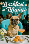 Fawn French bulldog wearing a floral scarf seated at a white tablecloth café table with pastries white roses utensils and a cocktail metal print