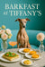 Italian Greyhound seated on a turquoise banquette beside a marble table with arugula-topped focaccia, mini lemon tarts, a macaroni-and-cheese cake and a pink cocktail