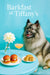 Fluffy Keeshond seated at a Tiffany-blue table with tomato cheese slider buns, herb scones, a pink cocktail, and a dahlia in a bud vase