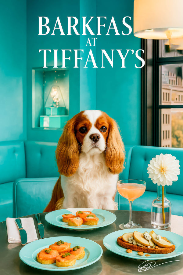 Ruby and white King Charles Cavalier seated on a Tiffany-blue banquette with salmon toasts, pear-and-cheese toast, and a pink cocktail on a steel tabletop