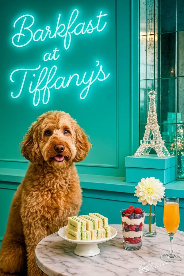 Apricot labradoodle seated before marble table with cucumber finger sandwiches berry parfait mimosa neon Barkfast at Tiffanys sign and crystal Eiffel Tower