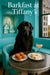Black Newfoundland with glossy coat seated on Tiffany-blue banquette beside a window