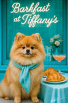 Fluffy Pomeranian wearing a teal scarf seated next to a Tiffany-blue table with two croissants and a pink spritz beneath a neon Barkfast at Tiffany’s sign