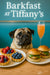 Fawn pug at a turquoise banquette with fruit tarts sliders and a peach cocktail on a wood café table