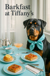 Rottweiler wearing a turquoise scarf seated at a round café table by a sunlit window in a stylish teal brunch setting