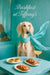 Slender Saluki wearing a flowing turquoise scarf seated on a tufted Tiffany-blue banquette beside a mirrored café wall