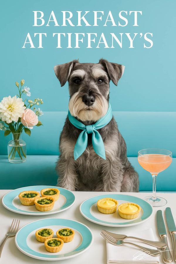 Whiskered Schnauzer wearing a turquoise scarf seated on a teal café banquette beside a vase of pastel flowers