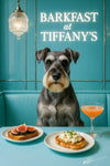 Schnauzer seated in a Tiffany blue booth beside a table with fig toast scrambled egg toast and a peach cocktail beneath a neon Barkfast at Tiffany’s sign