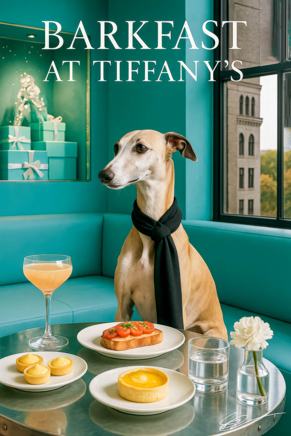 Whippet wearing a black scarf seated at a teal booth with lemon tartlets a lemon tart tomato toast a peach cocktail a glass of water and a white carnation in a vase
