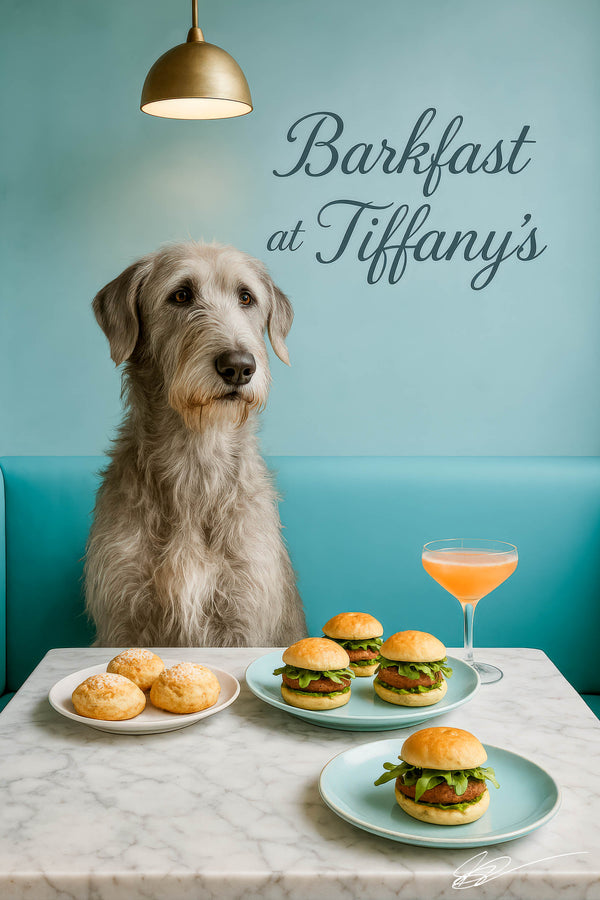 Wolfhound seated at a marble table with cheese scones miniature arugula sliders and a peach cocktail under a brass pendant in a teal dining nook