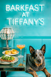 Australian Cattle Dog seated at a Tiffany-blue café booth with avocado toast topped with arugula and cheese, lemon swirl tarts, and a peach cocktail under a neon Barkfast sign