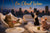Three cats lounging on cloud cushions sipping wine spritzes against a city skyline on a gleaming Metal Print