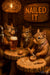 Three squirrels chiseling walnuts and toasting beers under a “Nailed It II” sign on Metal Print