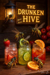 Wasps drinking colorful mason-jar cocktails under a “The Drunken Hive” sign on a Metal Print
